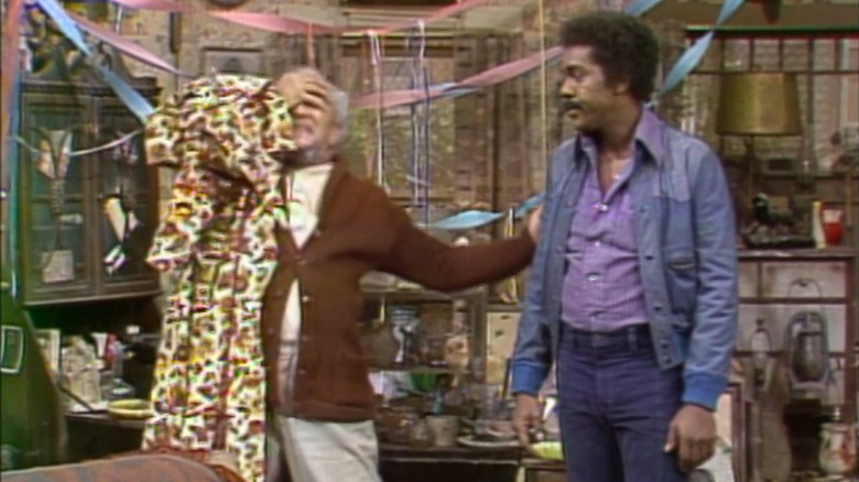 Fred covering is eyes while Lamont watches