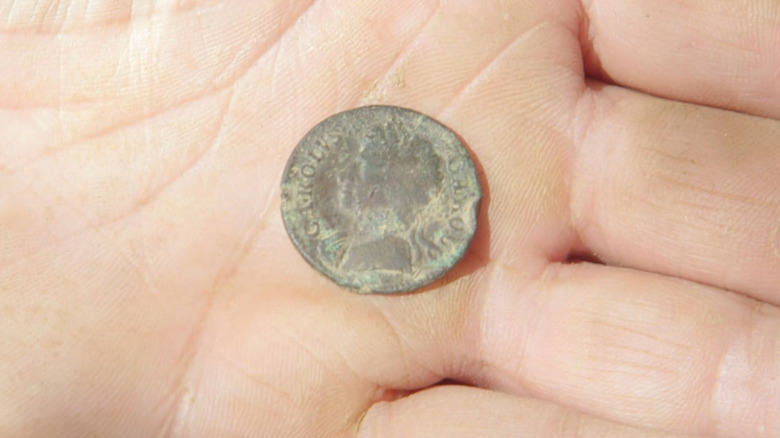 Hand holds English coin