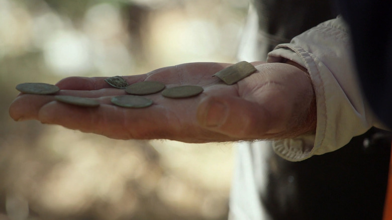 Hand holding coins and tag