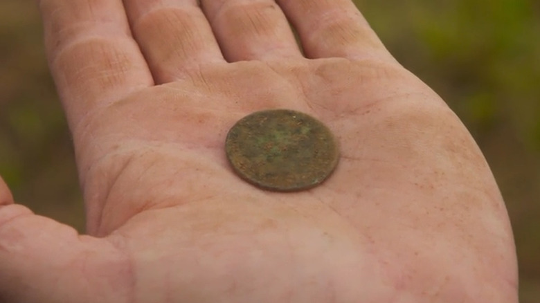 Hand holds large coin