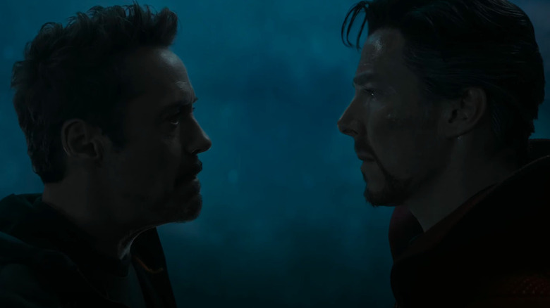 Tony Stark and Doctor Strange stare each other down inside a dimly-lit spaceship