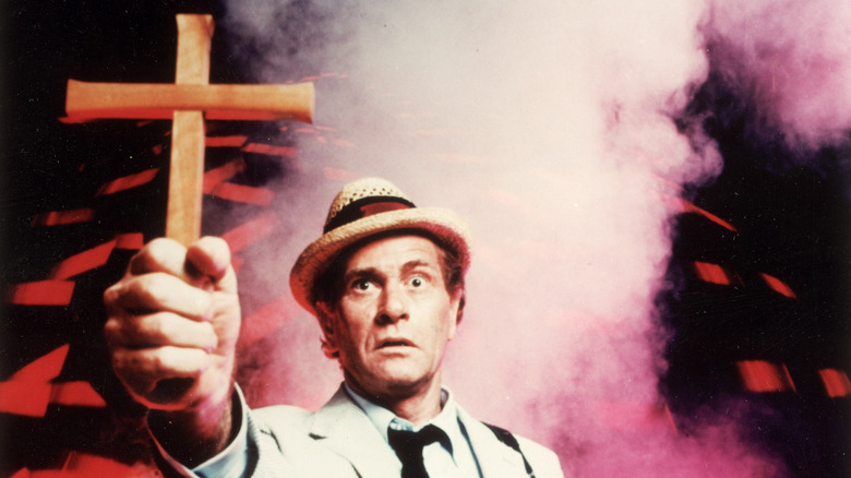 Kolchak holds a crucifix