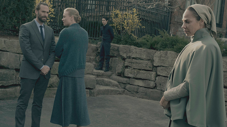 Rita walking next to Commander and Mrs. Waterford 