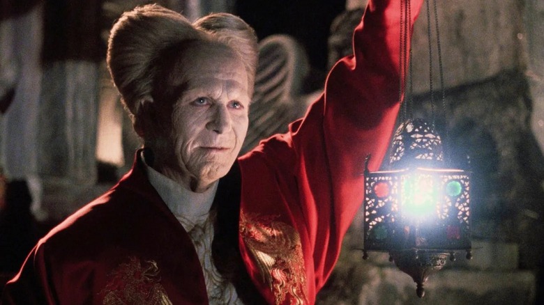 Dracula holds up a lantern