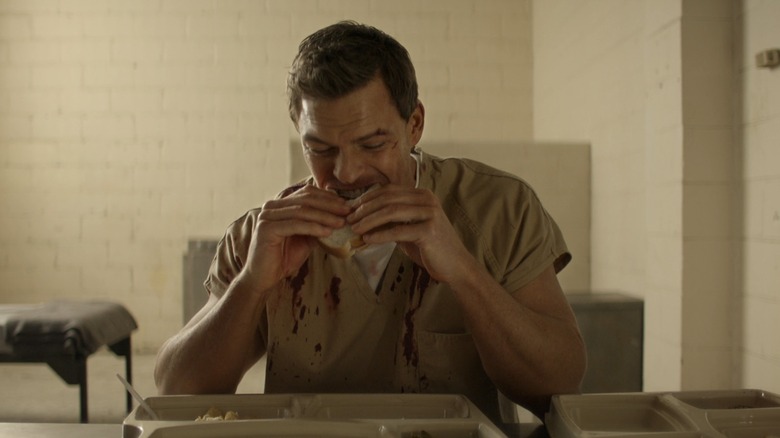 Jack Reacher eating sandwich in prison