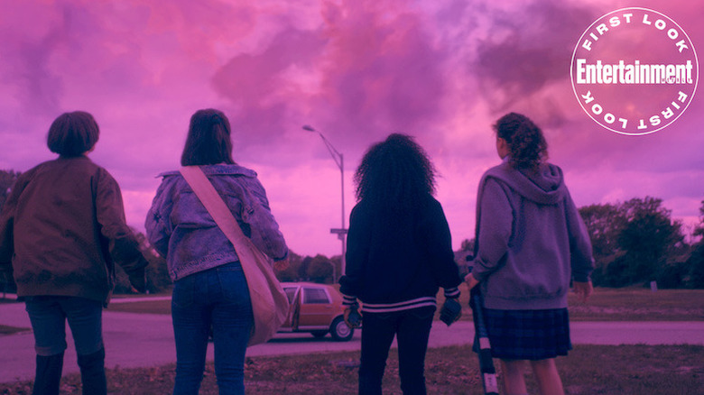 The Paper Girls looking at a purple sky