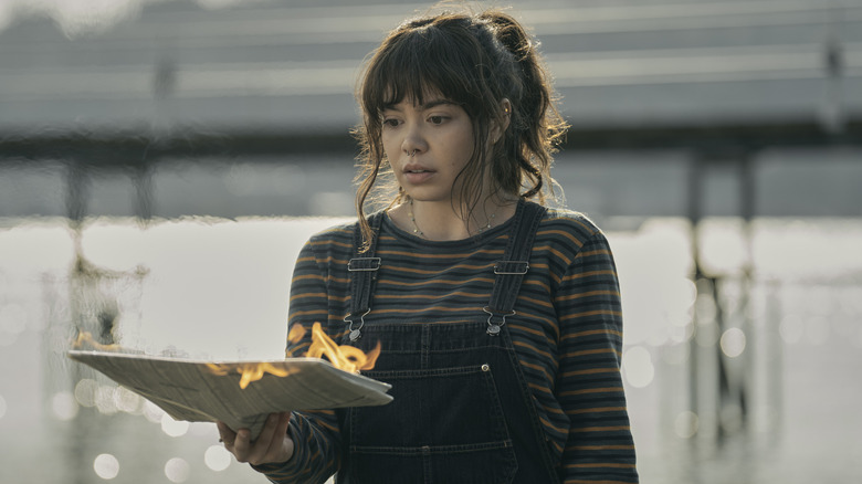 Auli'i Cravalho holding a newspaper