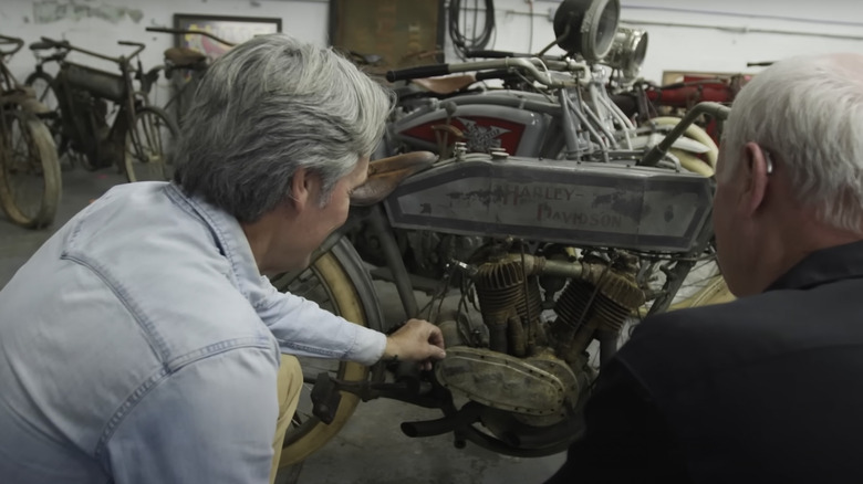 Mike Wolfe examining old Harley Davidson