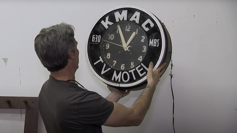 Mike Wolfe holding an old clock