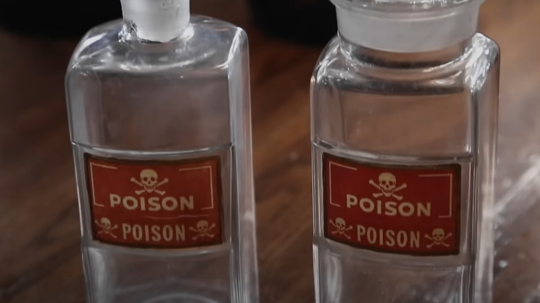 Close-up of two poison bottles