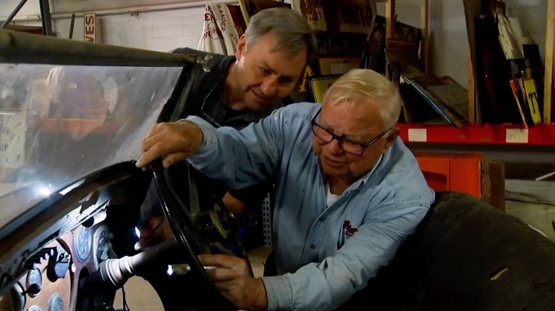 Bob Petersen looking at a car