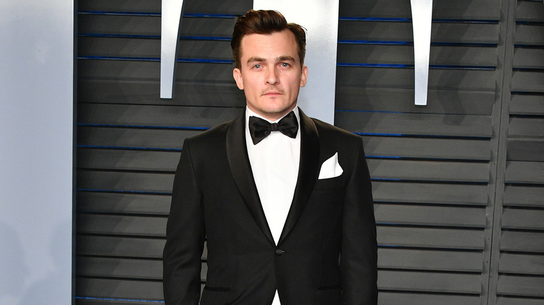 Rupert Friend poses at event 