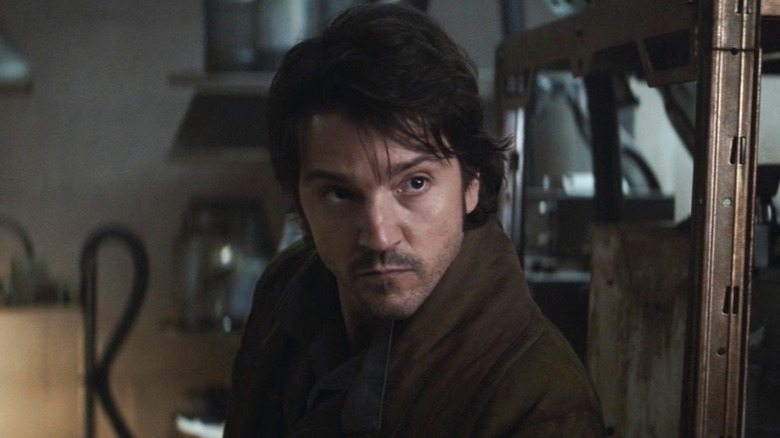 Cassian holding gun