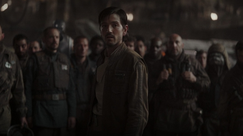 Cassian Andor standing beside a group of Rebel soldiers