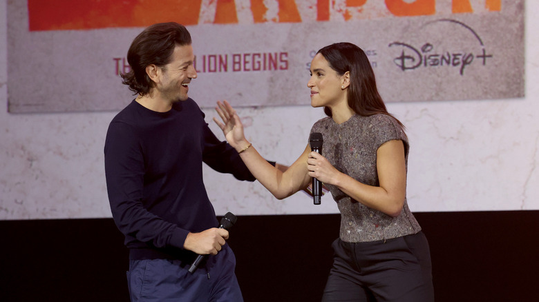 Diego Luna and Adria Arjona talking at D23 event