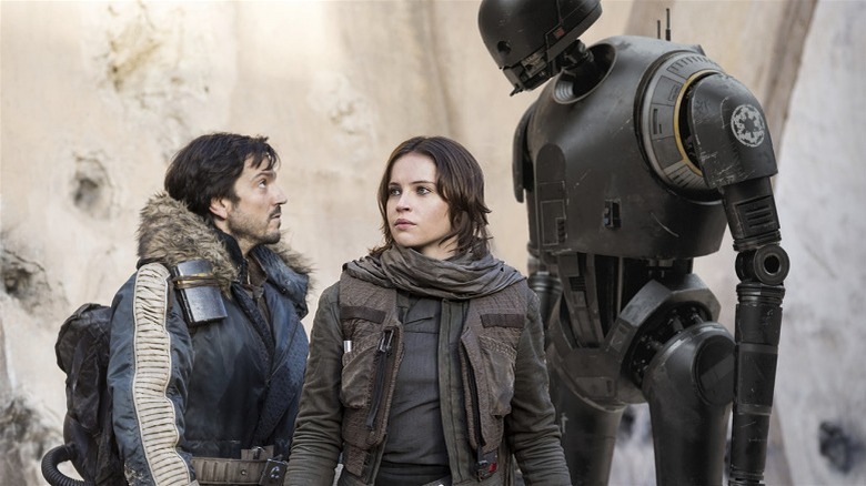 Cassian and K-2SO flanking Jyn