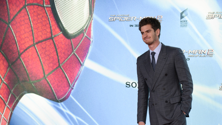 Andrew Garfield in front of a Spider-Man graphic