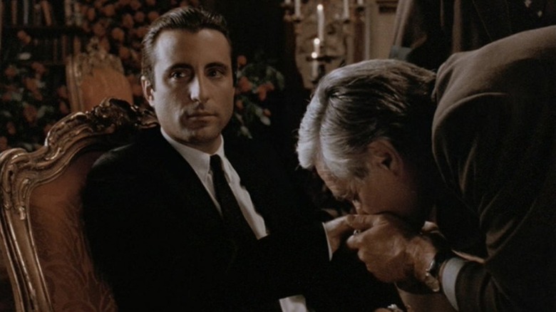 Man kissing Vincent Corleone's hand