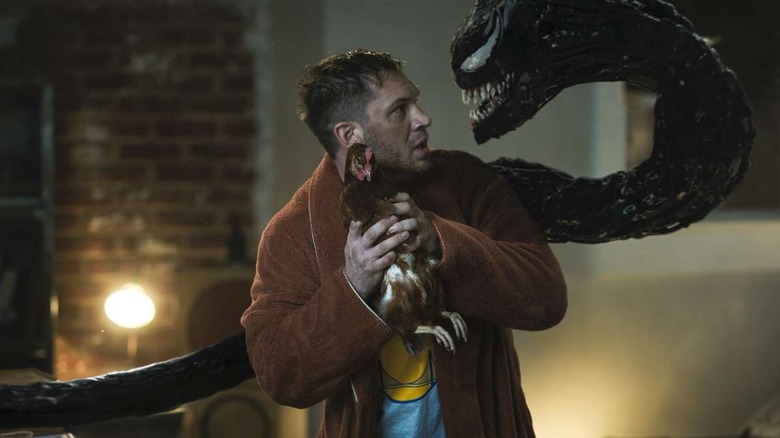 Eddie Brock holding a chicken in 'Venom: Let There Be Carnage'