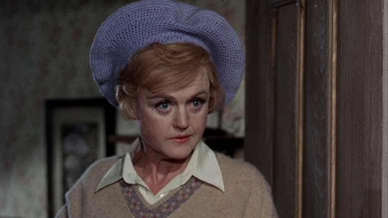 Angela Lansbury wearing a hat and sweater