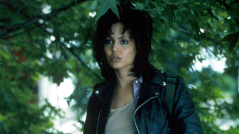 Angelina Jolie as Gia looks off to side under tree
