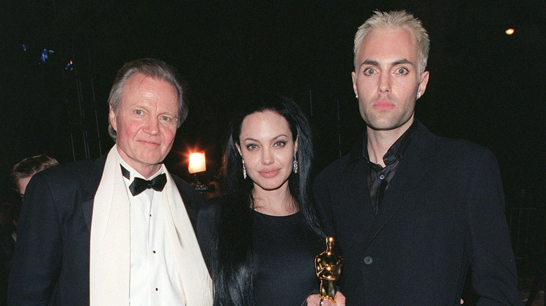 Angelina Jolie poses with father and brother