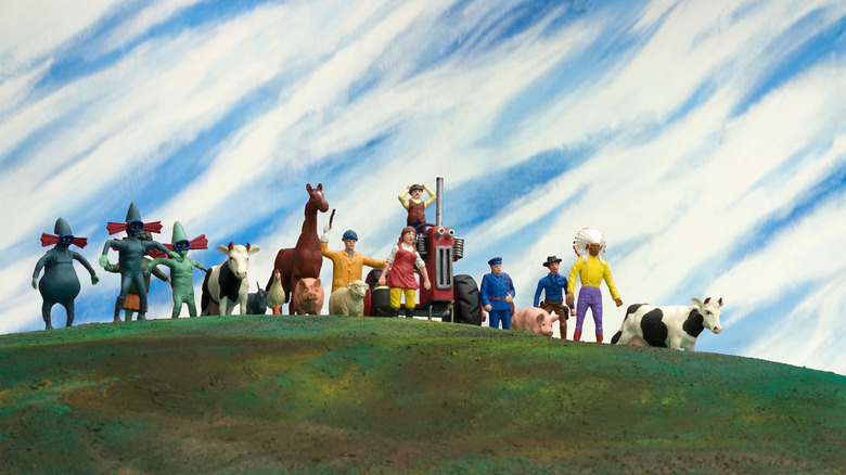 Characters standing on a green hill