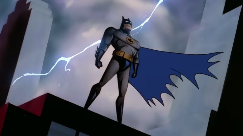 Batman on building while lightning strikes