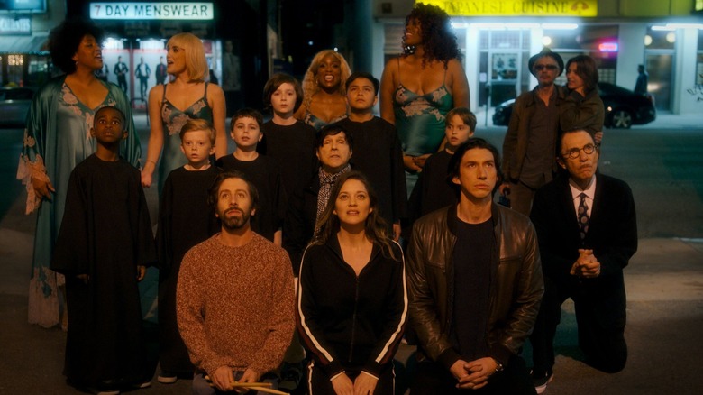 The fourth wall breaking opening number of Annette; Simon Helberg, Marion Cotillard, Adam Driver and Sparks in front - Leos Carax back right