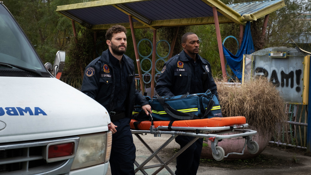 Steve and Dennis carry a stretcher in Synchronic