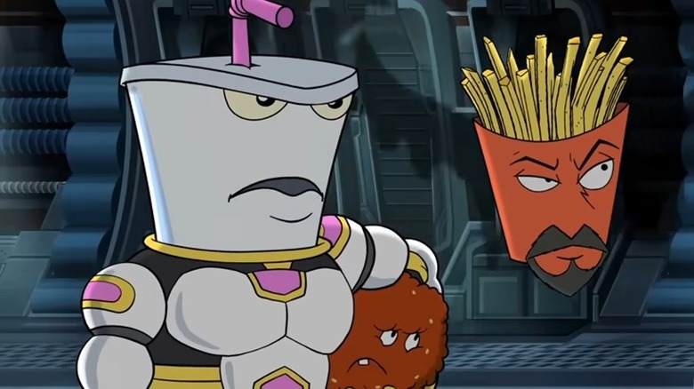 Master Shake (with a muscular body) holds Meatwad next to Frylock