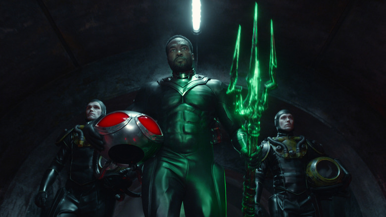 Black Manta walking with green trident