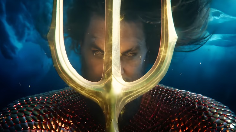 Aquaman holding trident in front of his face