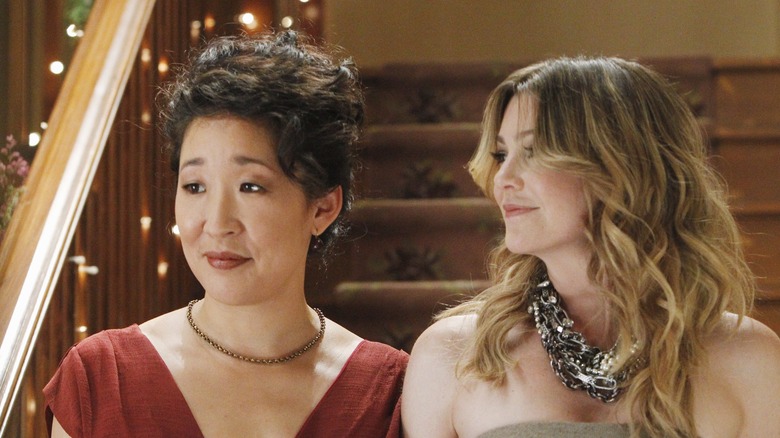 Cristina Yang and Meredith Grey walk down the stairs at a party on an episode of "Grey's Anatomy."