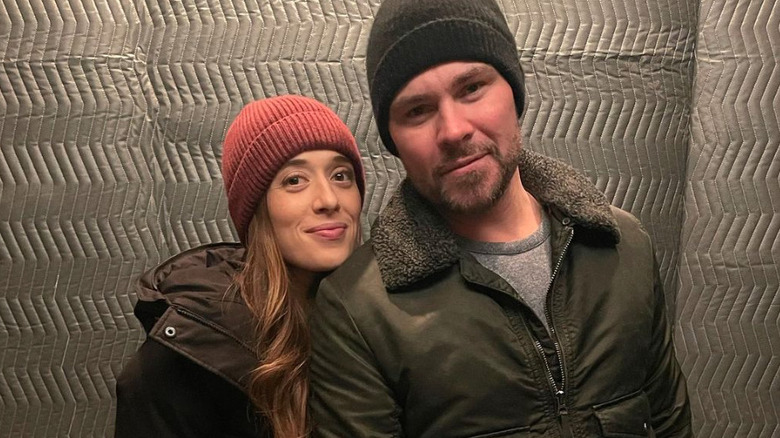 Marina Squerciati and Patrick Flueger wearing beanies