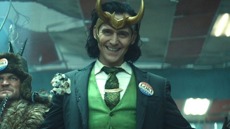 Tom Hiddleston as President Loki grinning