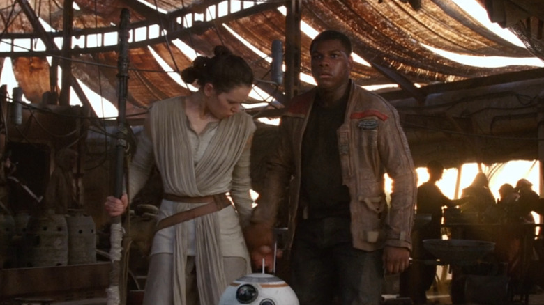 Finn grabs Rey's hand in Force Awakens