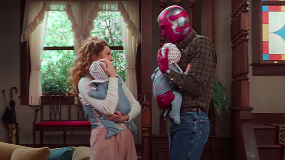 Wanda Maximoff and Vision holding babies at home