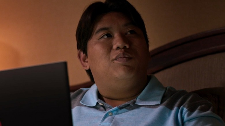 Ned looking away from laptop