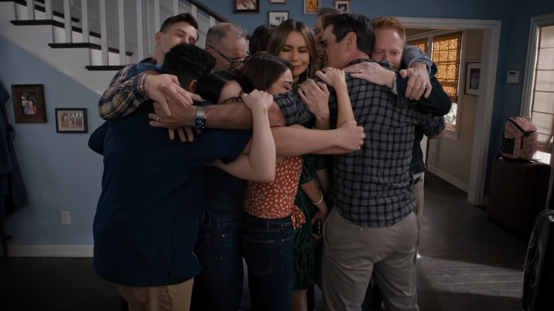 The Dunphy family hugging