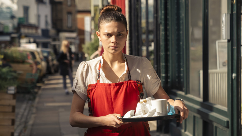 Ruby holding tray with dishes at work