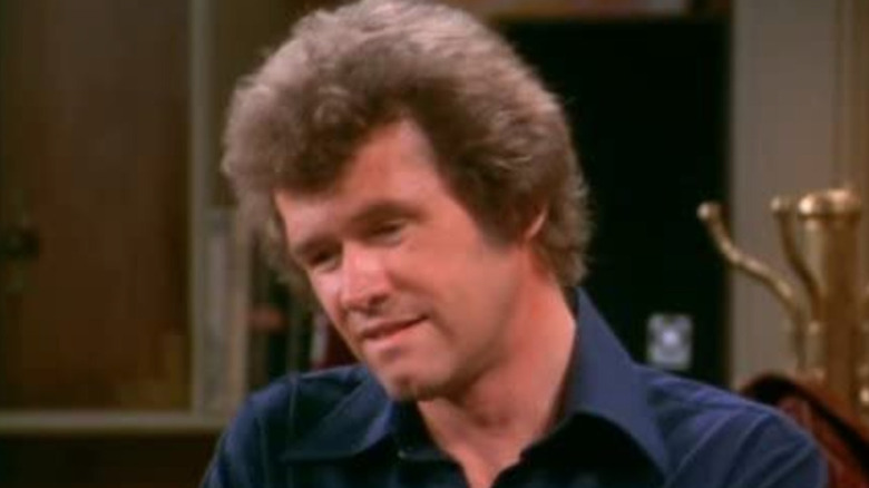 John Reilly with big hair and coat rack on Mary Tyler Moore