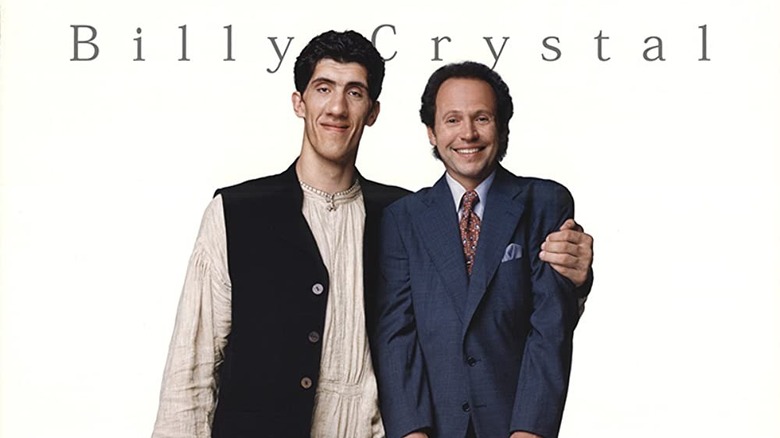 Gheorghe Mureșan holds up Billy Crystal