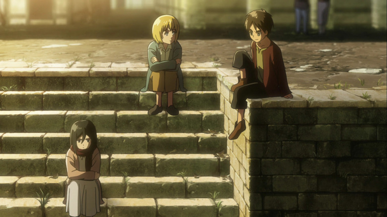 Young Eren sits with Armin and Mikasa