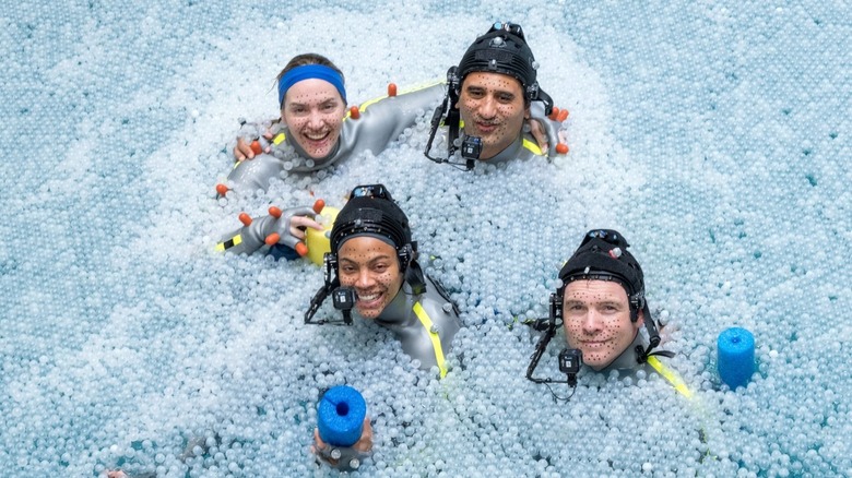 Kate Winslet, Cliff Curtis, Zoe Saldana, and Sam Worthington smiling on the water set of Avatar: The Way of Water