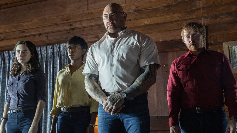 Dave Bautista. Rupert Grint, Abby Quinn, and Nikki Amuka-Bird in Knock at the Cabin