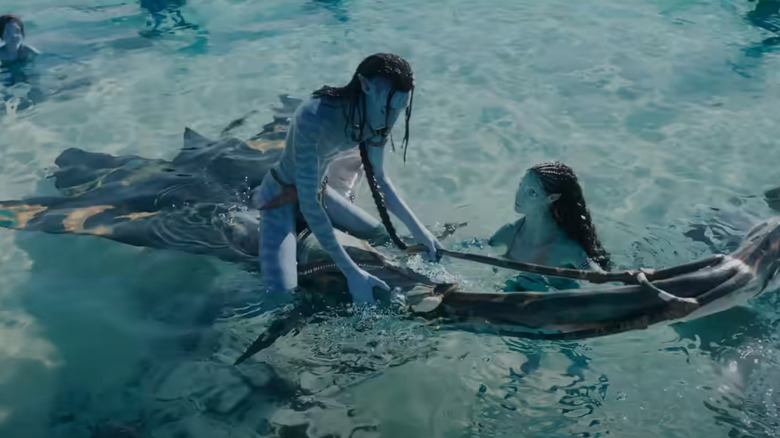 One of Jake's Na'vi children learns how to ride a sea-beast 