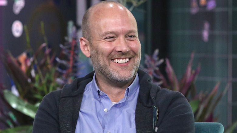 Stephen McFeely smiling while wearing a hoodie