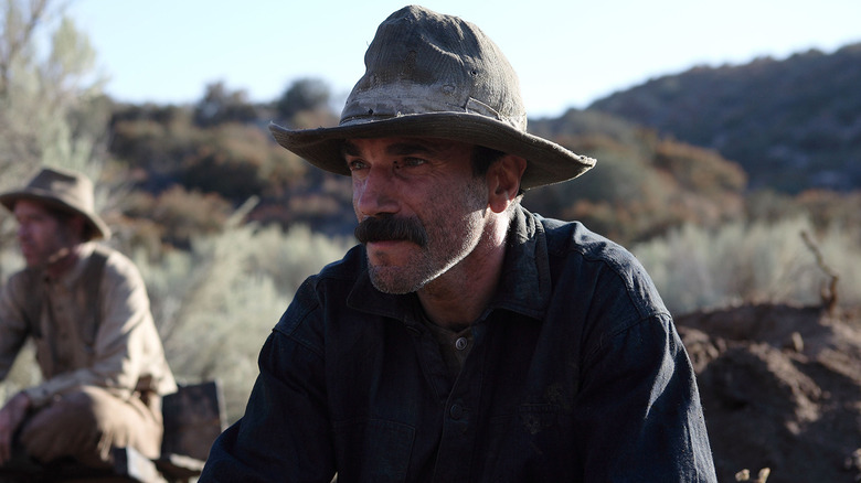 Daniel Plainview sitting outside