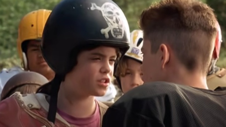 Becky wears a large helmet and confronts a boy